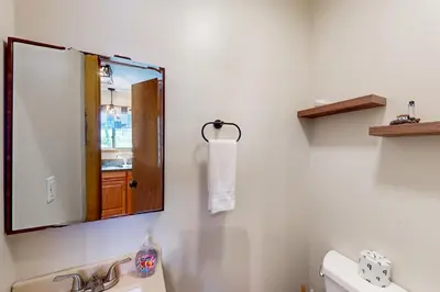 a bathroom with a mirror and a sink at Mountain Home at Camelback in Tannersville