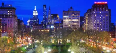 a view of a city at night with lights at Lovely Room at 3 bedroom Apt at the heart of East Village in New York
