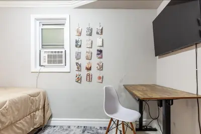 a bedroom with a bed and a desk and a table at Lovely Room at 3 bedroom Apt at the heart of East Village in New York