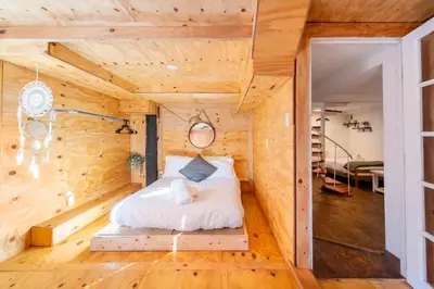 a bedroom in a log cabin with a bed in it at Serene Catskills Retreat with Deck in Woodbourne