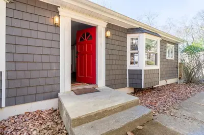 a house with a red door and a window at Serene Catskills Retreat with Deck in Woodbourne