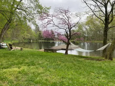 a park with a hammock and a lake with trees at Roundtop Mansion-Breathtaking View, indoor Pool in Wrightsville