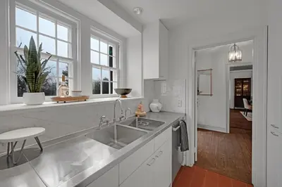 a white kitchen with a sink and a counter at Roundtop Mansion-Breathtaking View, indoor Pool in Wrightsville