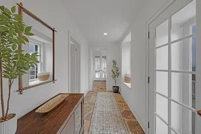 a hallway with white walls and a mirror on the wall at Roundtop Mansion-Breathtaking View, indoor Pool in Wrightsville