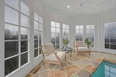 a room with two chairs and a table and windows at Roundtop Mansion-Breathtaking View, indoor Pool in Wrightsville