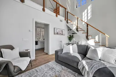 a living room with a couch and a staircase at The Roundtop Chalet romantic couples getaway in Wrightsville