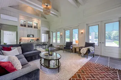 a living room with a couch and a table at Pool Cottage at Roundtop Estate couples oasis in Wrightsville