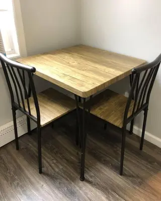 a wooden table and two chairs sitting next to a table at Private 2-bedroom apartment, free parking, direct bus to NYC Manhattan only 2 blocks away, MetLife Stadium FIFA World Cup 25 minutes away in Linden