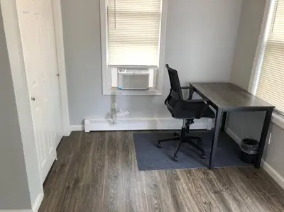 an office with a desk and a chair in a room at Private 2-bedroom apartment, free parking, direct bus to NYC Manhattan only 2 blocks away, MetLife Stadium FIFA World Cup 25 minutes away in Linden