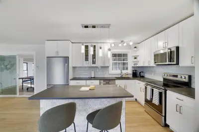 a kitchen with white cabinets and a table and chairs at (NEW) Blue Mtn Poconos Retreat Htd pool pet frndly in Effort