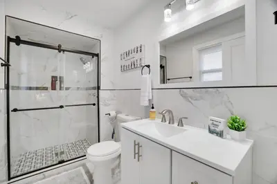 a bathroom with a shower and a toilet and a sink at (NEW) Blue Mtn Poconos Retreat Htd pool pet frndly in Effort