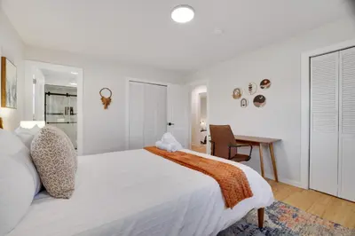a bedroom with a large white bed and a desk at (NEW) Blue Mtn Poconos Retreat Htd pool pet frndly in Effort