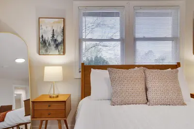 a bedroom with a bed and a table with a lamp at (NEW) Blue Mtn Poconos Retreat Htd pool pet frndly in Effort