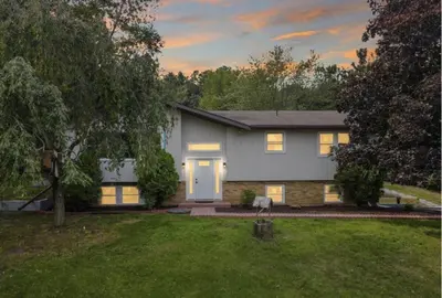 a gray house with a white door in a yard at (NEW) Blue Mtn Poconos Retreat Htd pool pet frndly in Effort