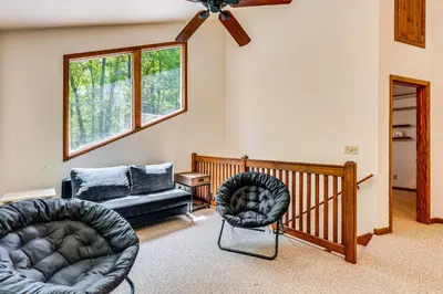 a living room with two chairs and a couch at Creek Access and Deck Family Pocono Pines Cottage in Pocono Pines