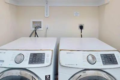 two washing machines sitting next to each other in a room at Pocono Waterside Escape in Tobyhanna