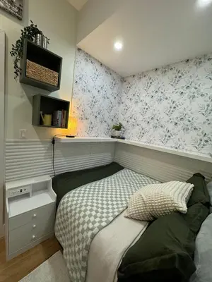 a small bedroom with a bed and floral wallpaper at Columbus House in New York