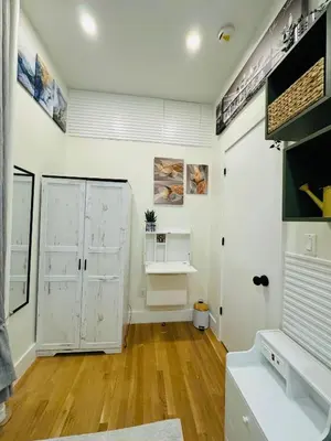 a room with white doors and a wooden floor at Columbus House in New York