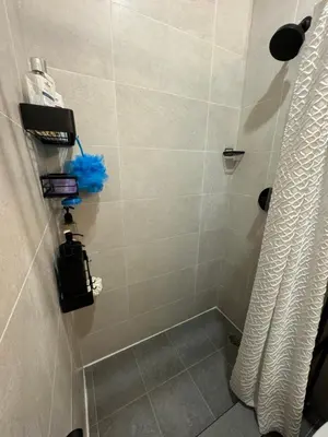 a bathroom with a shower with a shower curtain at Columbus House in New York