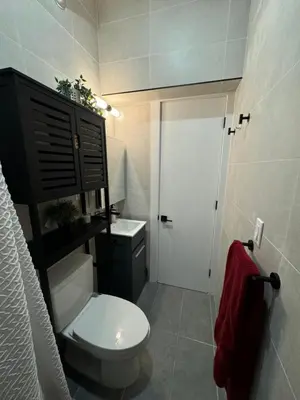 a small bathroom with a toilet and a sink at Columbus House in New York