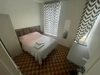 a small bedroom with a bed and a window at Hudson Yard 408 in New York