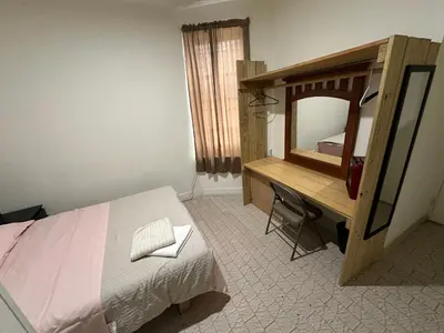 a bedroom with a bed and a desk and a mirror at Hudson Yard 408 in New York