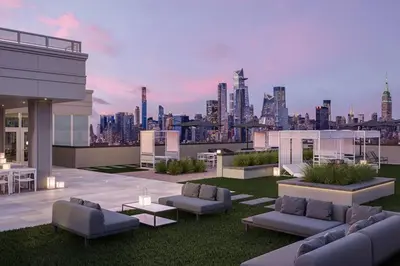 a rooftop patio with a view of a city at Empire State View - Luxury Apt - Shuttle to NYC in Hoboken