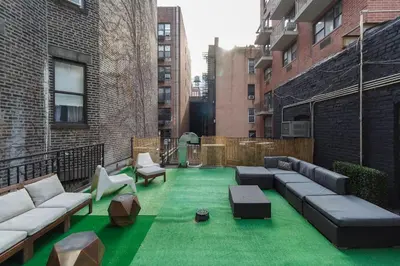 a rooftop patio with green grass in a building at Park South Central 3 Bedroom with Private Terrace in New York