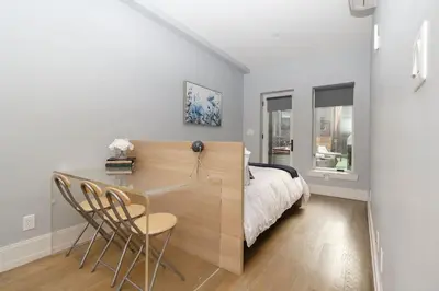 a bedroom with a bed and a table and chairs at Park South Central 3 Bedroom with Private Terrace in New York