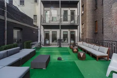 a patio with green grass and couches on a building at Park South Central 3 Bedroom with Private Terrace in New York