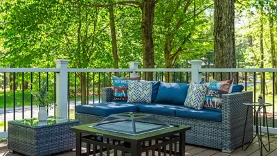 a blue couch and a table on a patio at Walk to the Lake Firepit and Sunroom Tomhickon in Arrowhead Lake