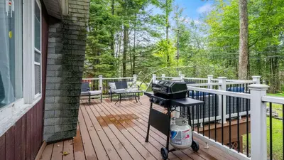 a bbq grill on a deck on a house at Walk to the Lake Firepit and Sunroom Tomhickon in Arrowhead Lake