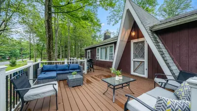 a deck with a couch and chairs on a house at Walk to the Lake Firepit and Sunroom Tomhickon in Arrowhead Lake