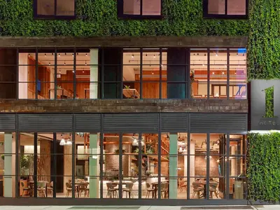 a building with a lot of windows and plants at 1 Hotel Central Park in New York