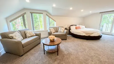 a living room with a bed and a couch at Four Seasons For Fun Bed & Breakfast in Lakeville