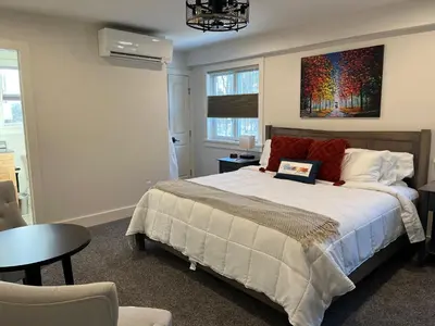 a bedroom with a bed with a painting on the wall at Four Seasons For Fun Bed & Breakfast in Lakeville