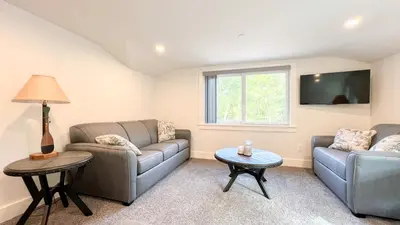 a living room with two couches and a table at Four Seasons For Fun Bed & Breakfast in Lakeville