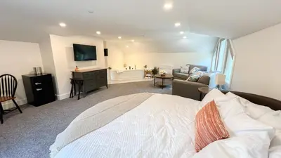 a bedroom with a bed and a living room at Four Seasons For Fun Bed & Breakfast in Lakeville