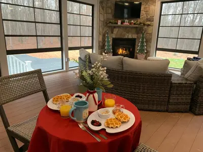 a table with breakfast food on it with a fireplace at Four Seasons For Fun Bed & Breakfast in Lakeville