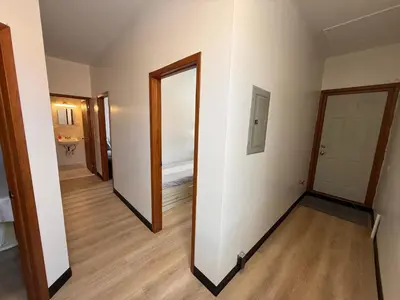 an empty room with a mirror and a hallway at Sunny Home in Sunbury