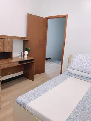 a room with two beds and a desk and a bed at Sunny Home in Sunbury