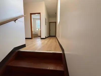 an empty hallway with a stairway leading into a room at Sunny Home in Sunbury