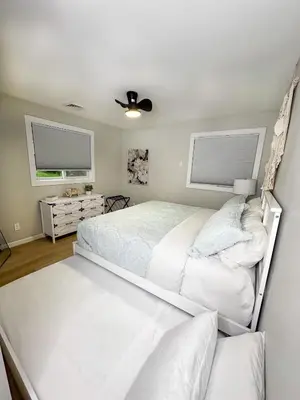 a bedroom with two beds and two windows at Rustic Poconos Ranch w Game Room in Tobyhanna