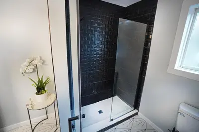 a shower with a glass door in a bathroom at Rustic Poconos Ranch w Game Room in Tobyhanna
