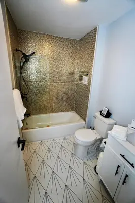 a bathroom with a toilet and a tub and a sink at Rustic Poconos Ranch w Game Room in Tobyhanna