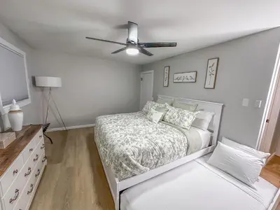 a bedroom with a bed and a ceiling fan at Rustic Poconos Ranch w Game Room in Tobyhanna