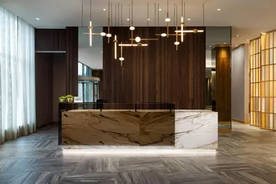 a lobby with a large marble reception desk at AC Hotel by Marriott Newtown Square in Newtown Square