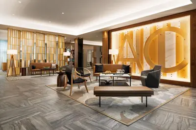 a lobby of a hotel with chairs and a large lettering at AC Hotel by Marriott Newtown Square in Newtown Square
