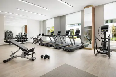 a gym with treadmills and elliptical machines at AC Hotel by Marriott Newtown Square in Newtown Square