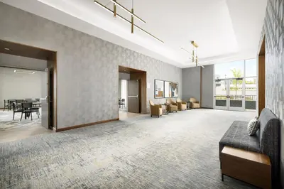 a living room with a couch and a dining room at AC Hotel by Marriott Newtown Square in Newtown Square